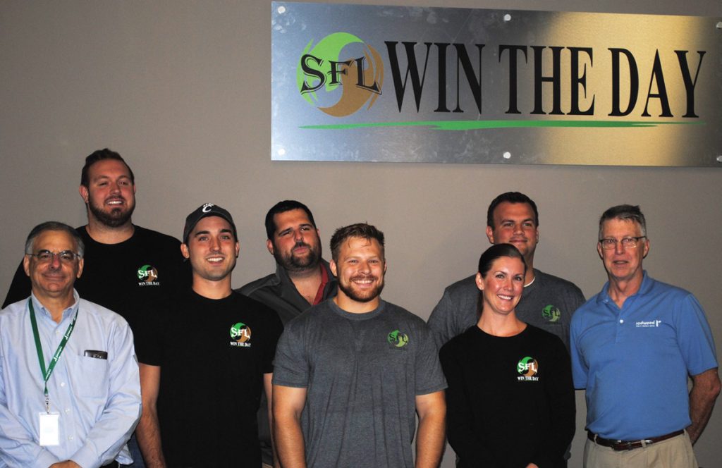 Employees of Service First Logistics, who presented the donation