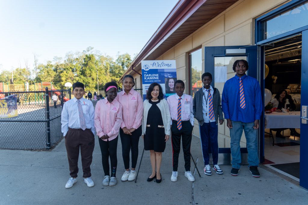 Darlene Kamine outside Roberts Academy with students.